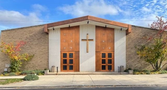 A church with a cross on the front of it.