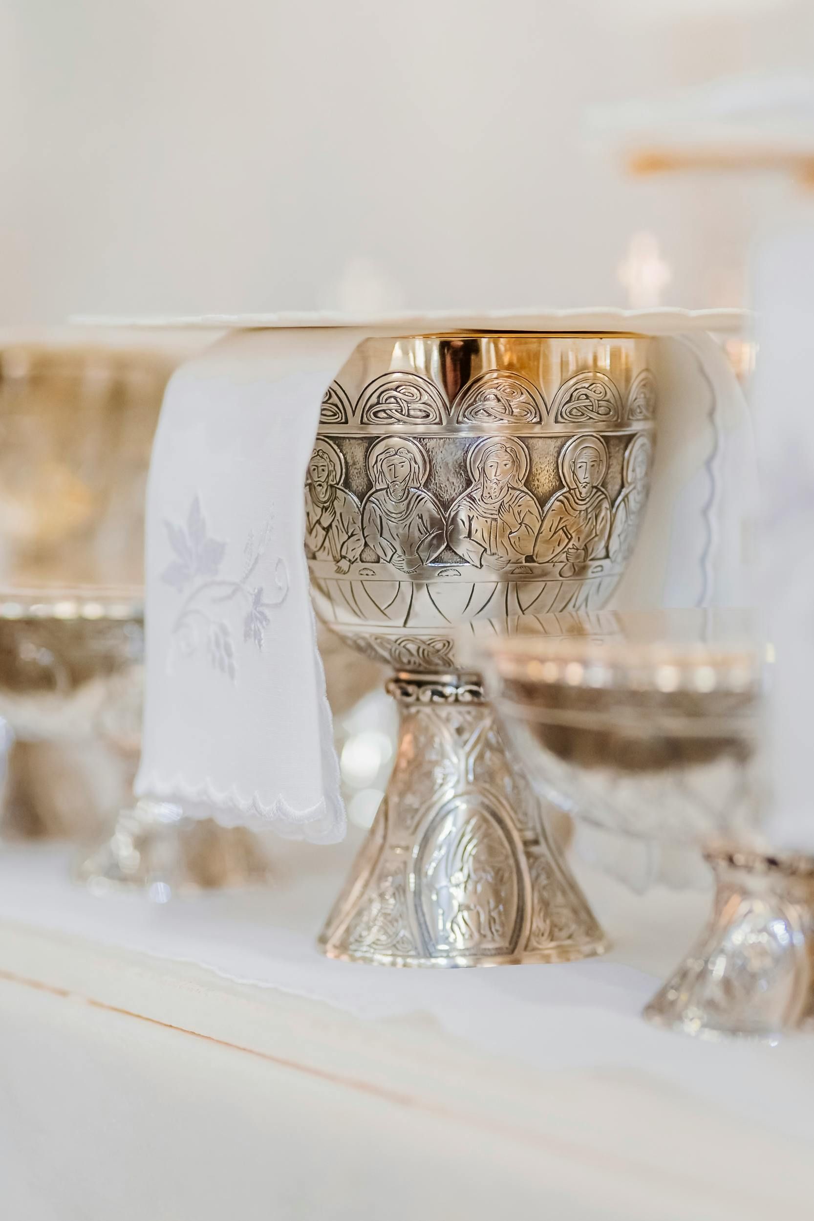 A close up of a silver chalice on a table.