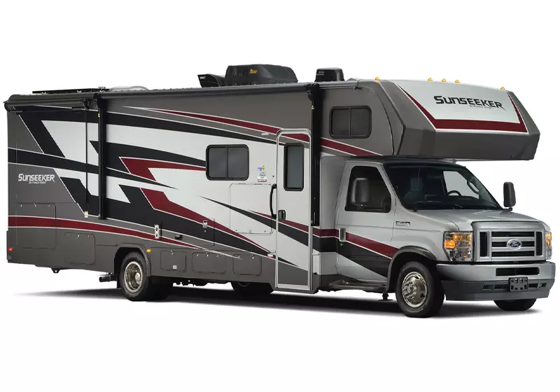 A silver and red rv is parked on a white background.