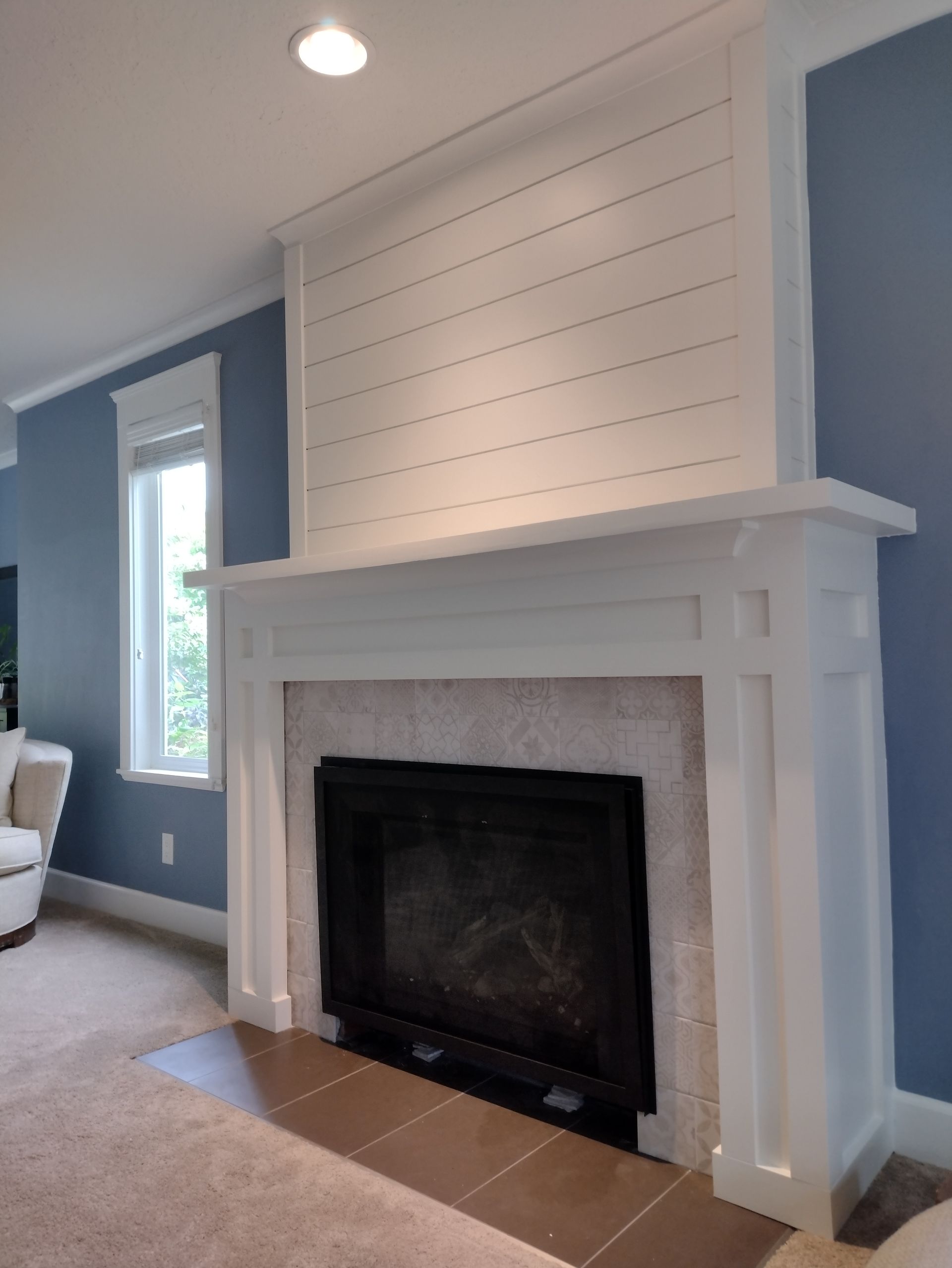 A living room with a fireplace and blue walls