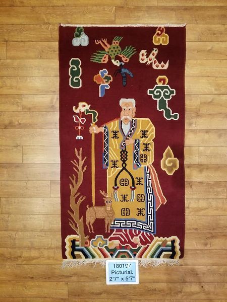 Red tapestry with an elderly figure in a yellow robe, holding a staff, with a deer, bird, and cloud designs.