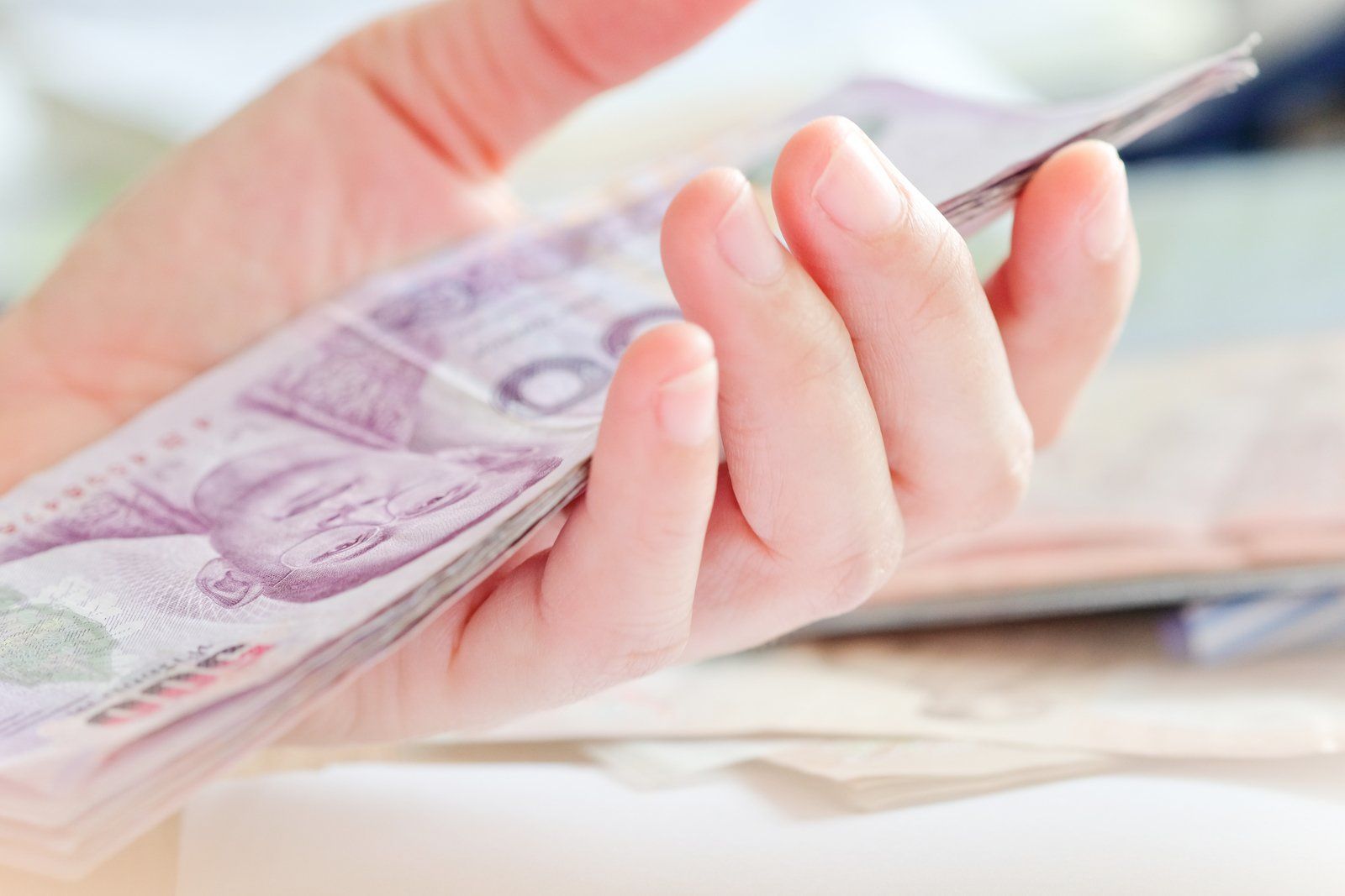 woman holding paper bills