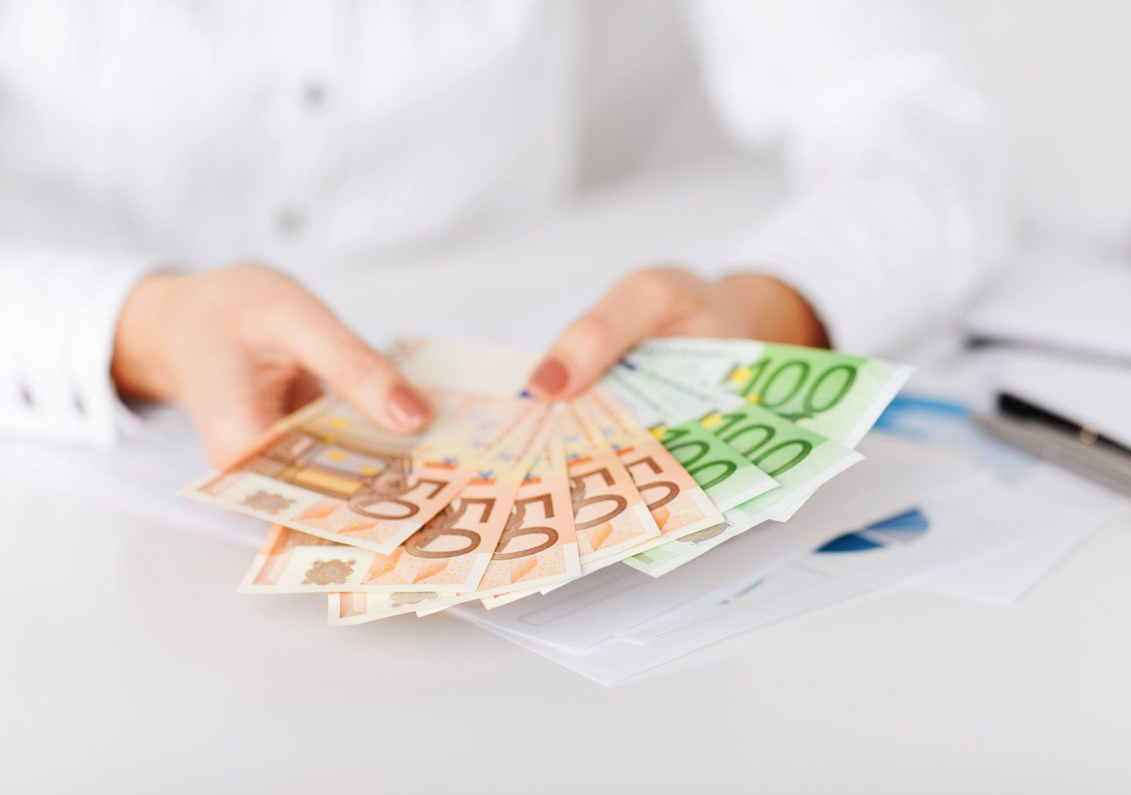 woman holding foreign currency she has exchanged