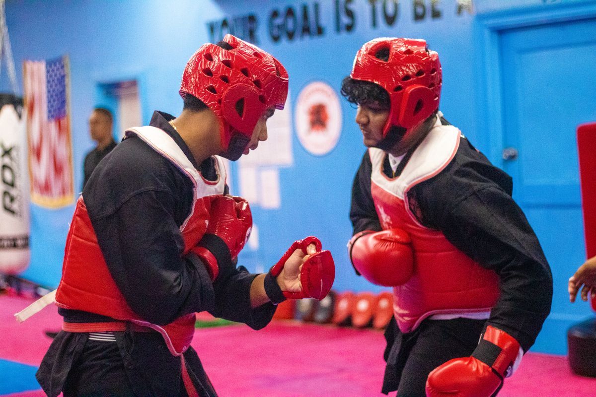 Kids and adults practicing padwork drills at Universal Mixed Martial Arts in South Richmond Hill, NY
