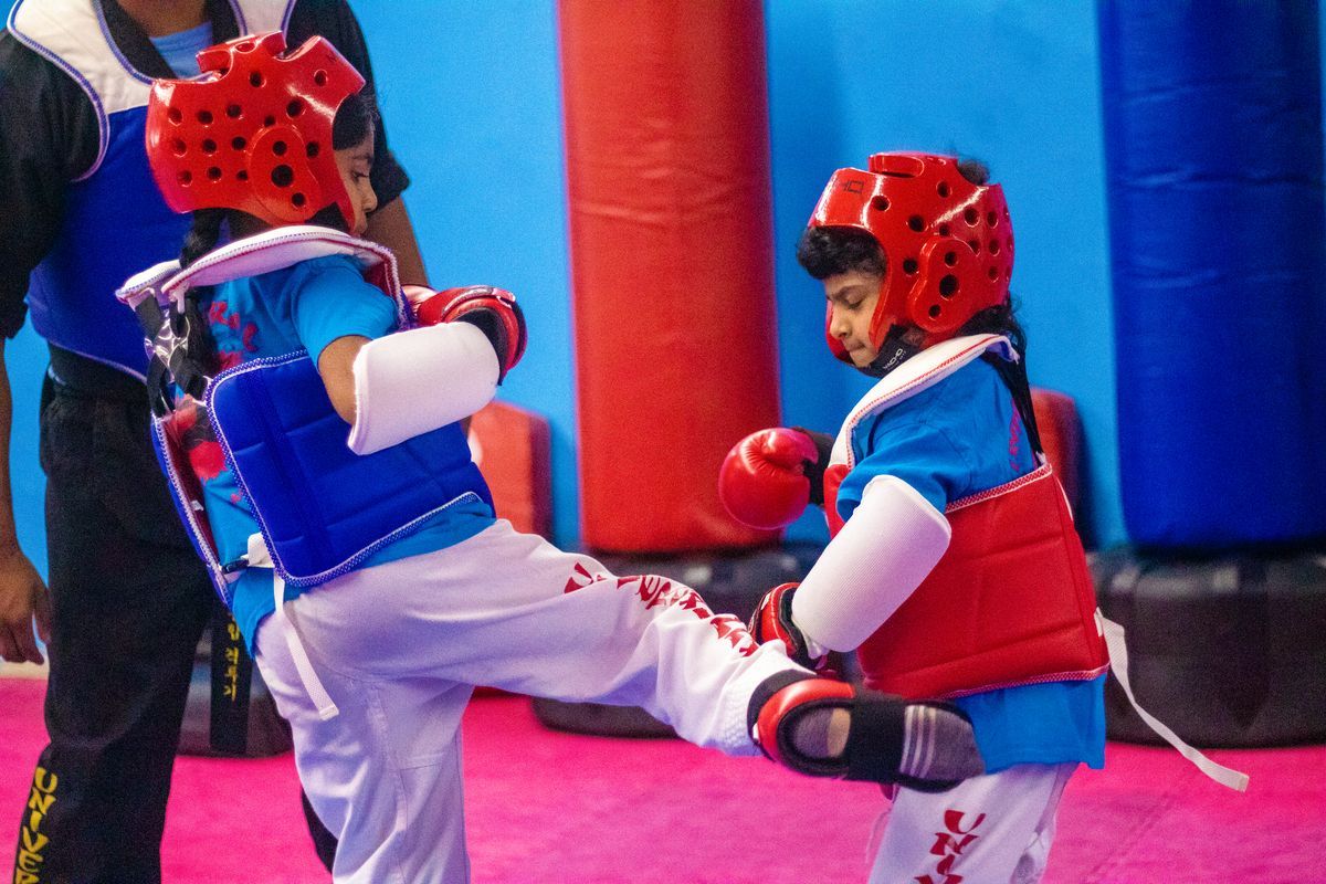 Kids practicing controlled MMA drills at Universal Mixed Martial Arts in South Richmond Hill, NY to build confidence.
