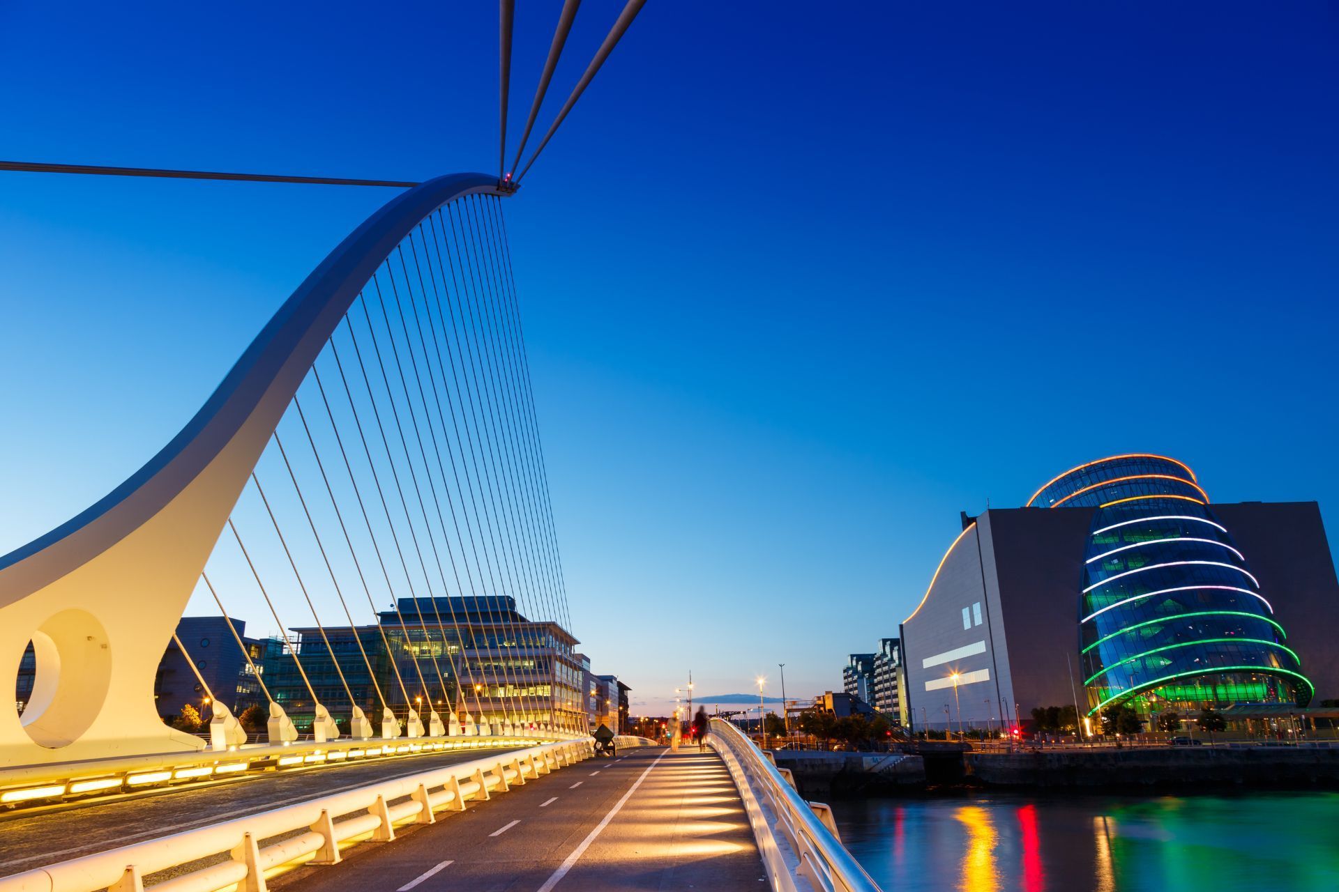 a dublin bridge over a body of water with buildings in the background .
