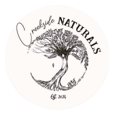 A logo for a company called creekside naturals with a tree in the middle.