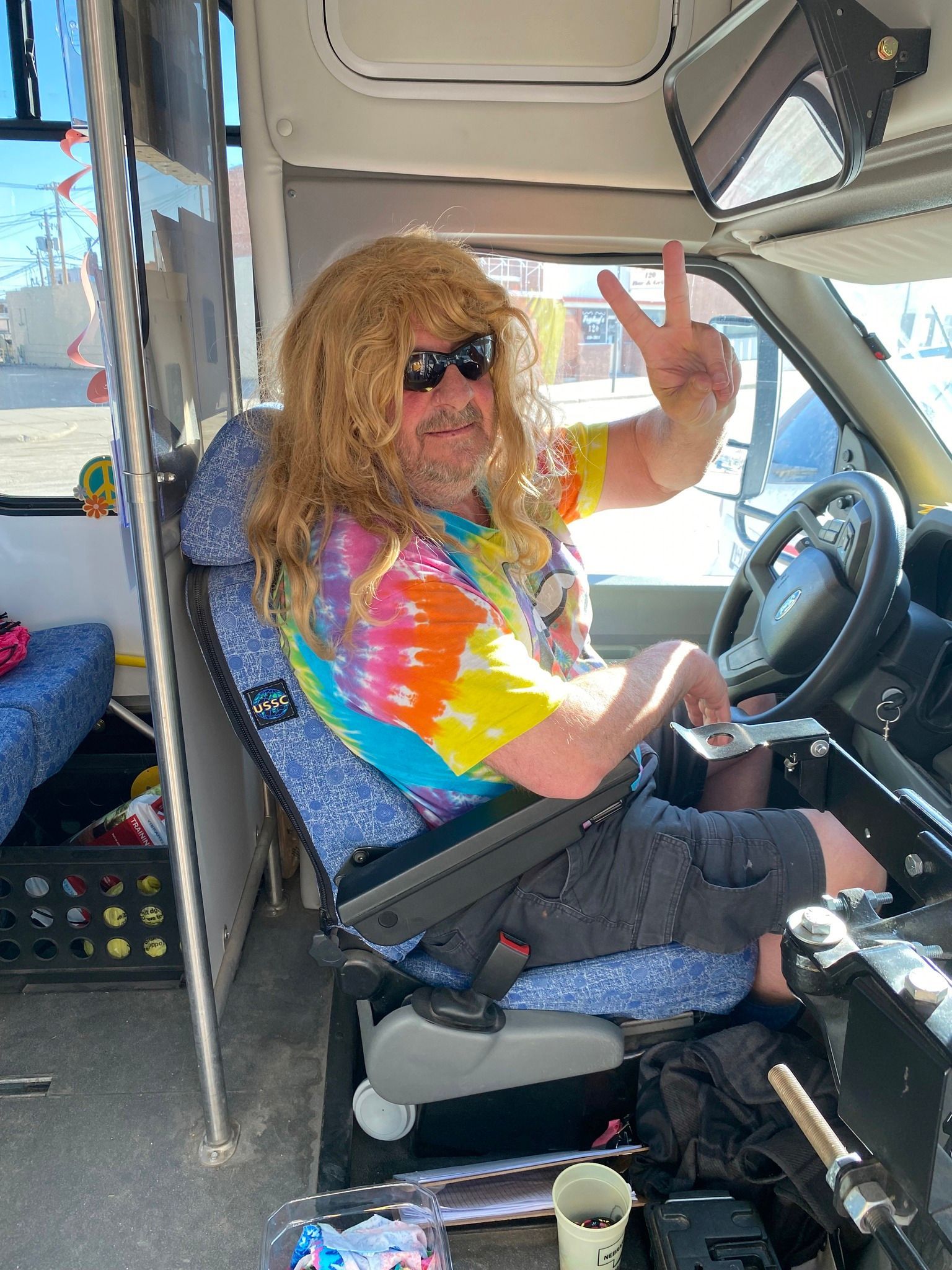 photo of a bus driver dressed up as a 70s hippy