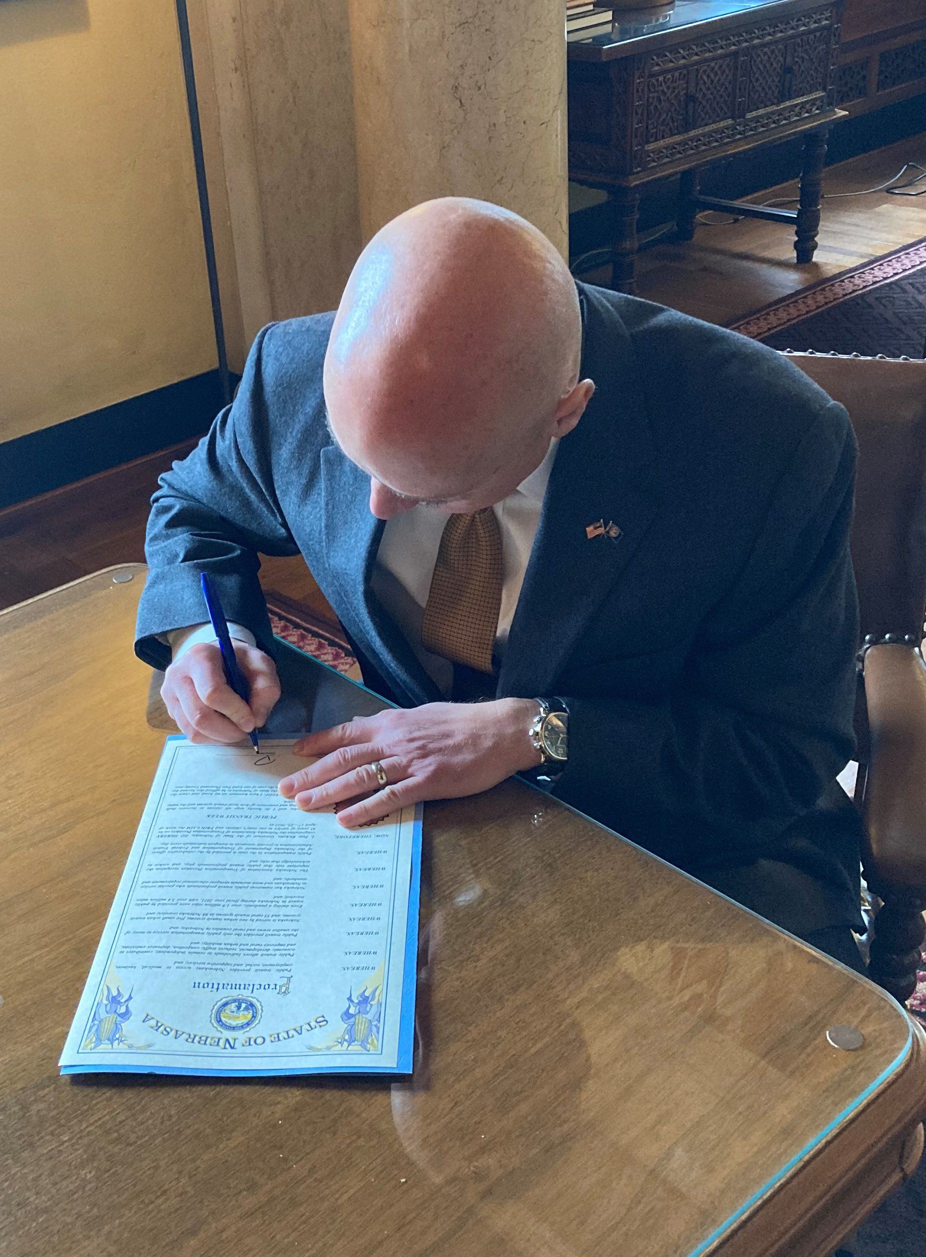 photo of Nebraska Governor Pete Ricketts signing the 2022 Nebraska Public Transit Week proclamation