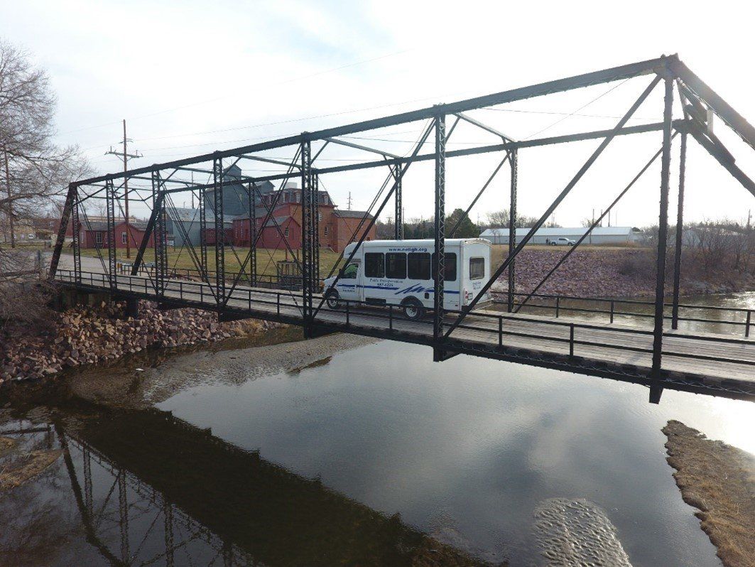 photo of Neligh Dial-A-Ride's bus crossing the Neligh Mill Bridge