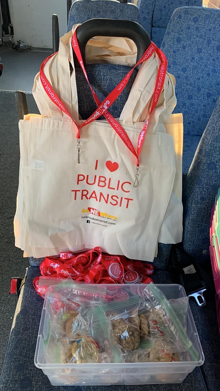 photo of the Nebraska Public Transit Week promotional items, a canvas bag, lanyards, and pop sockets