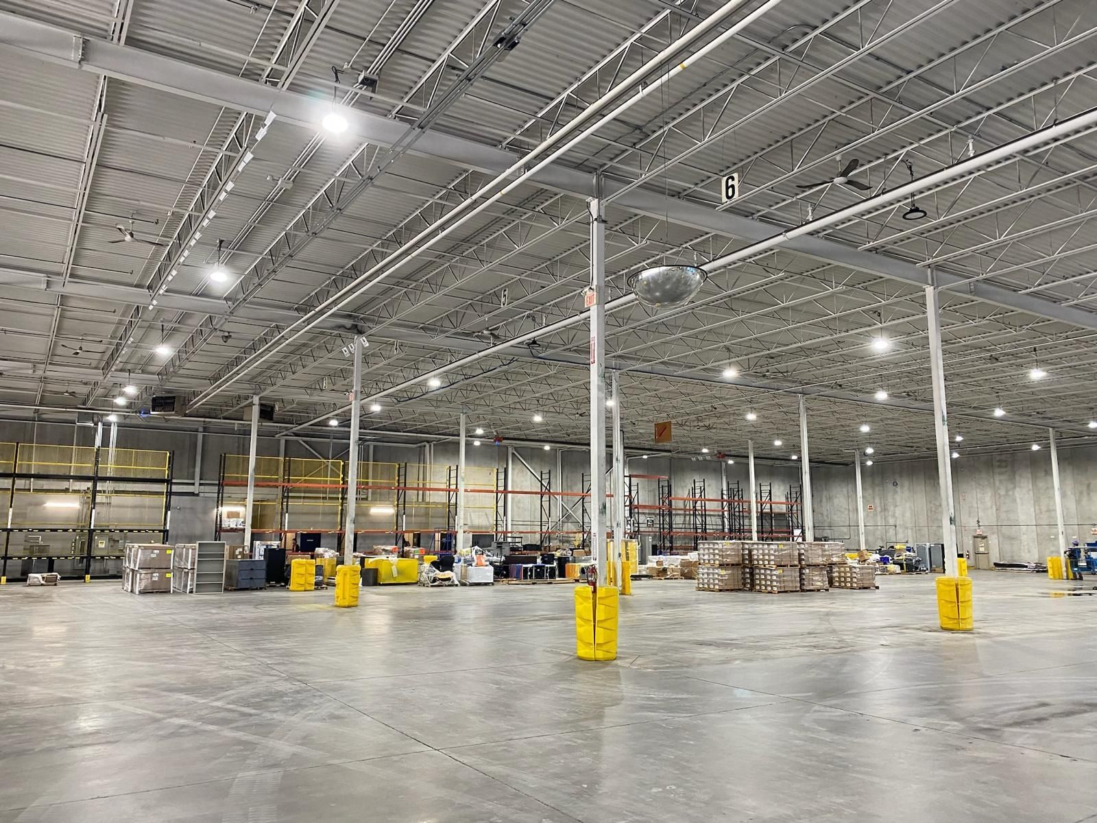 A large warehouse filled with lots of boxes and pallets.