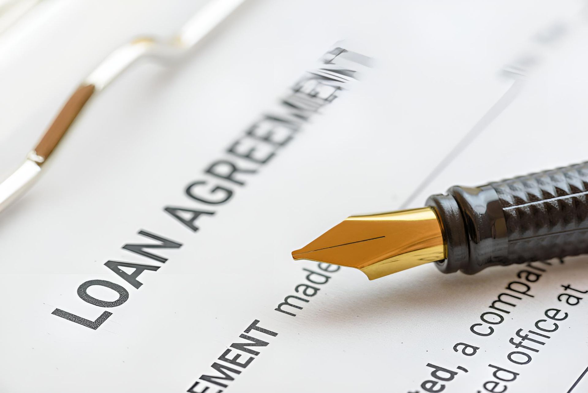 A fOuntain Pen is Sitting on Top of a Loan Agreement — Bradley J Bragg - Solicitor in Atherton, QLD