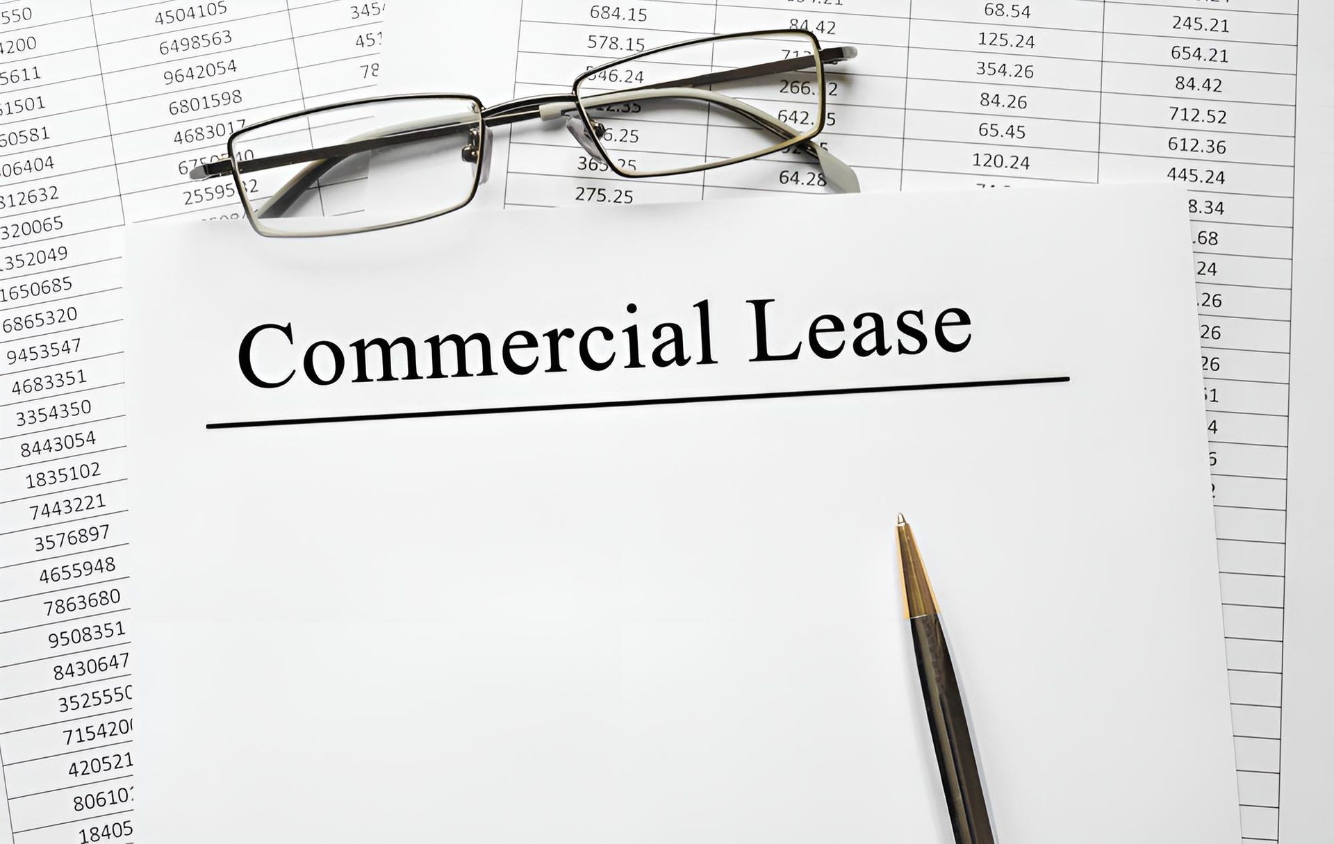 A Pair of Glasses on Top of a Piece of Paper That Says Commercial Lease — Bradley J Bragg - Solicitor in Atherton, QLD
