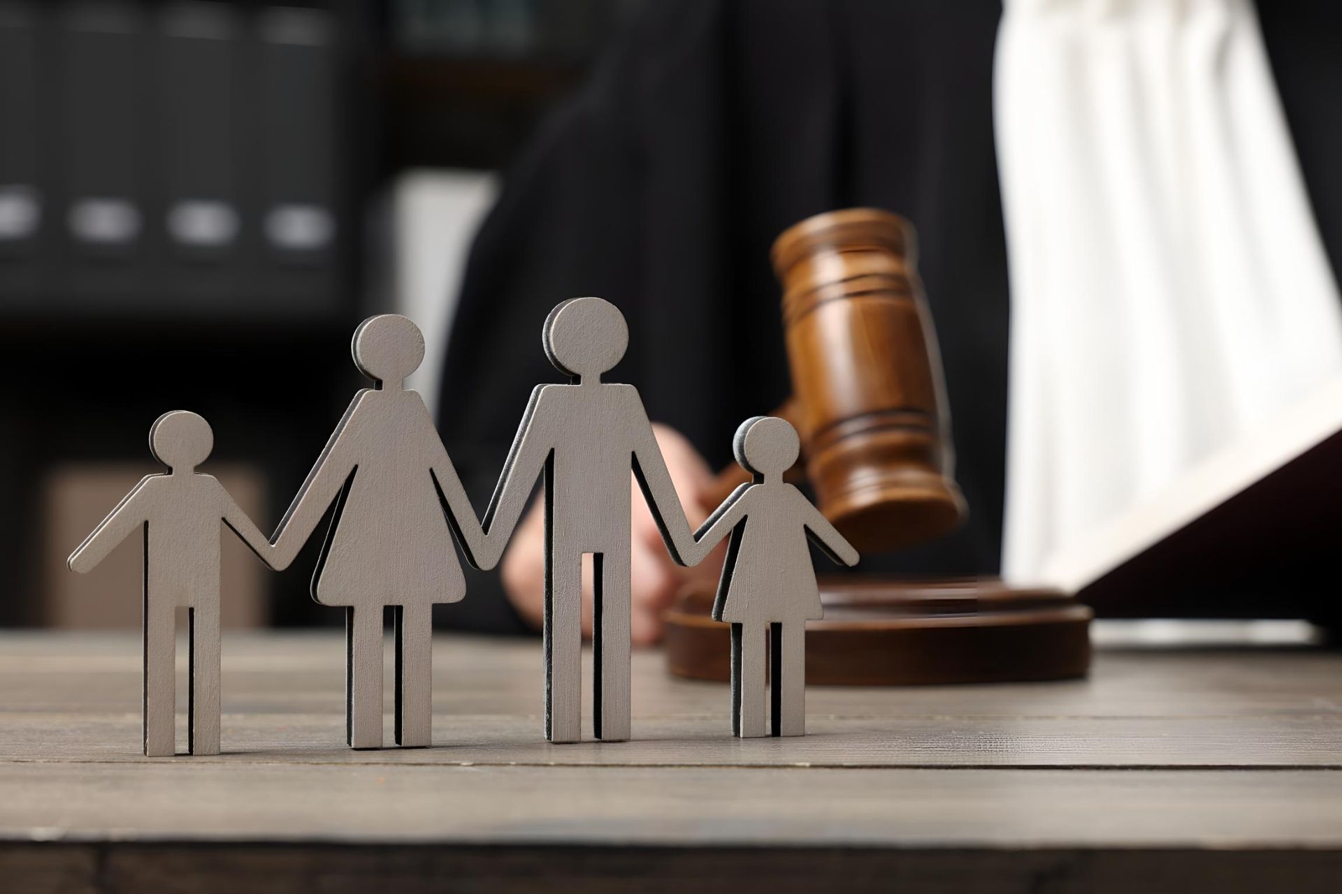 A Judge is Sitting at a Table With a Wooden Family and a Wooden Gavel — Bradley J Bragg - Solicitor in Atherton, QLD