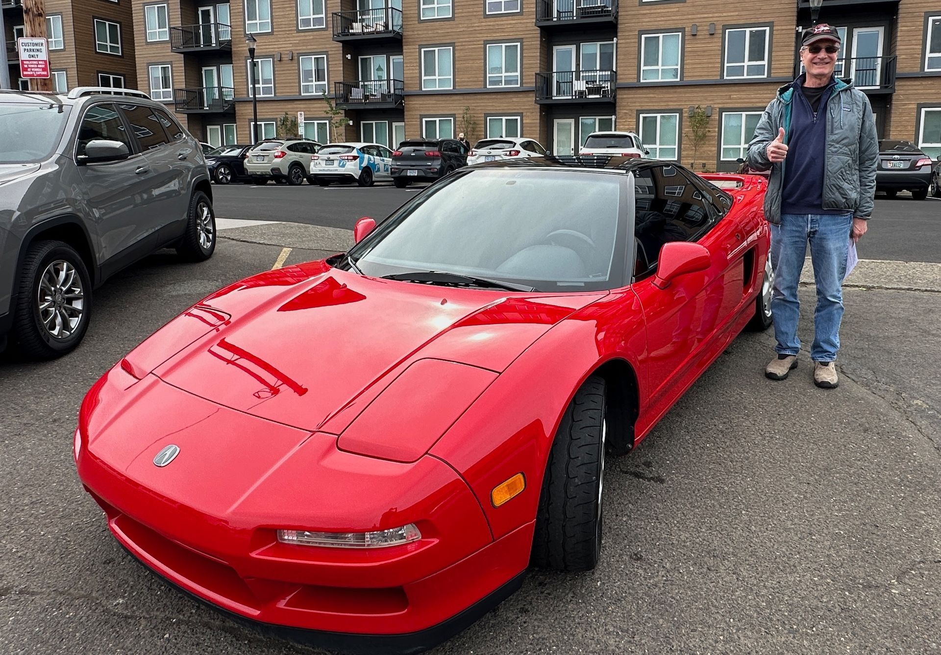 proud owner standing next to freshly ceramic coated Acura NSX in Beaverton