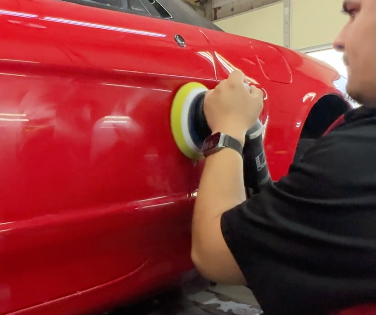polishing a classic red 1993 Acura NSX