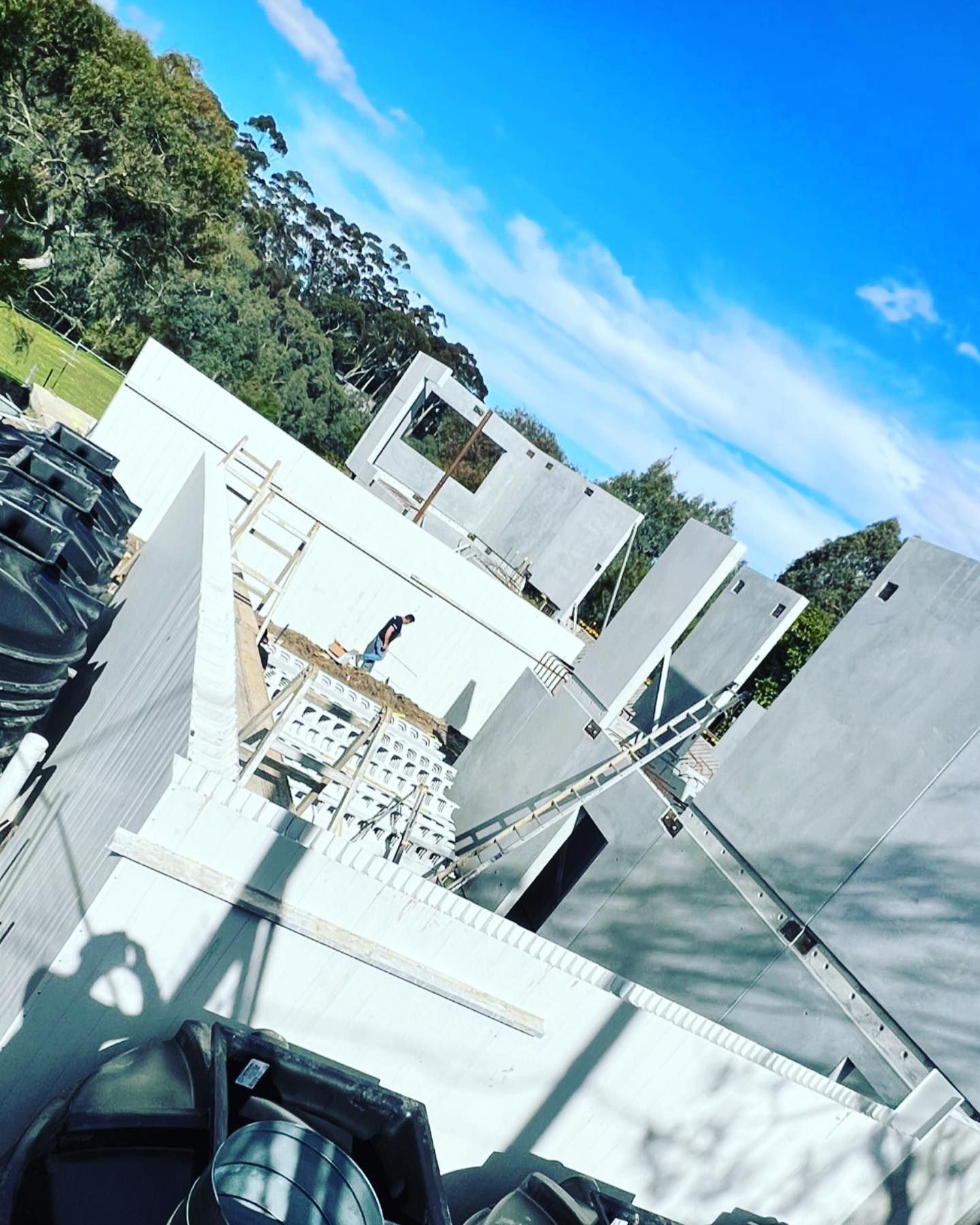 A building under construction with a blue sky in the background