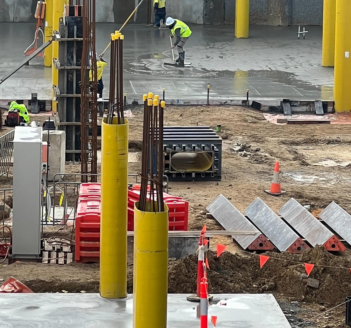 A construction site with a lot of yellow poles