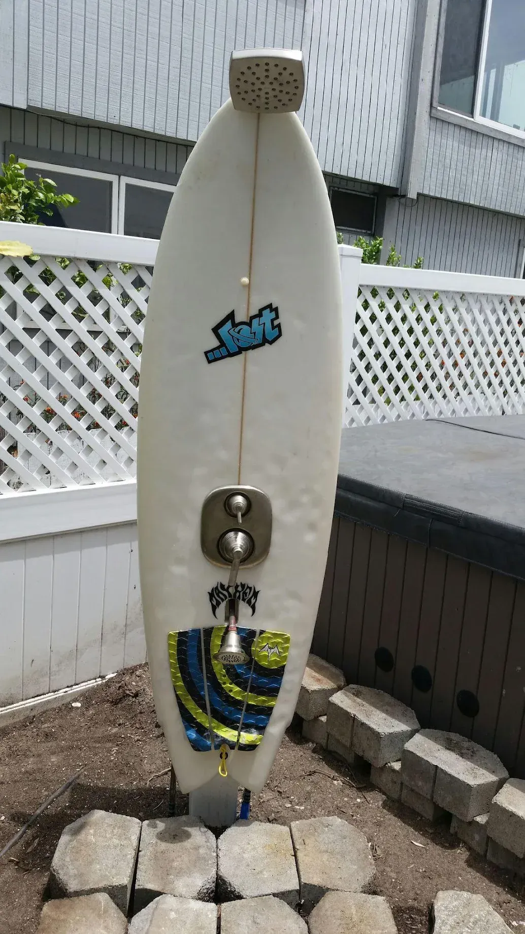 A white surfboard with the word surf on it
