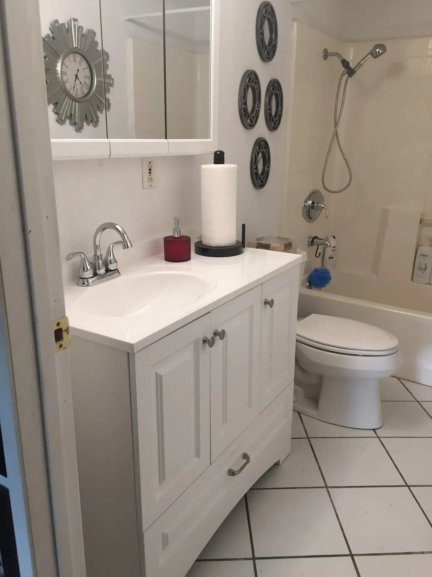 A bathroom with a toilet a sink and a mirror