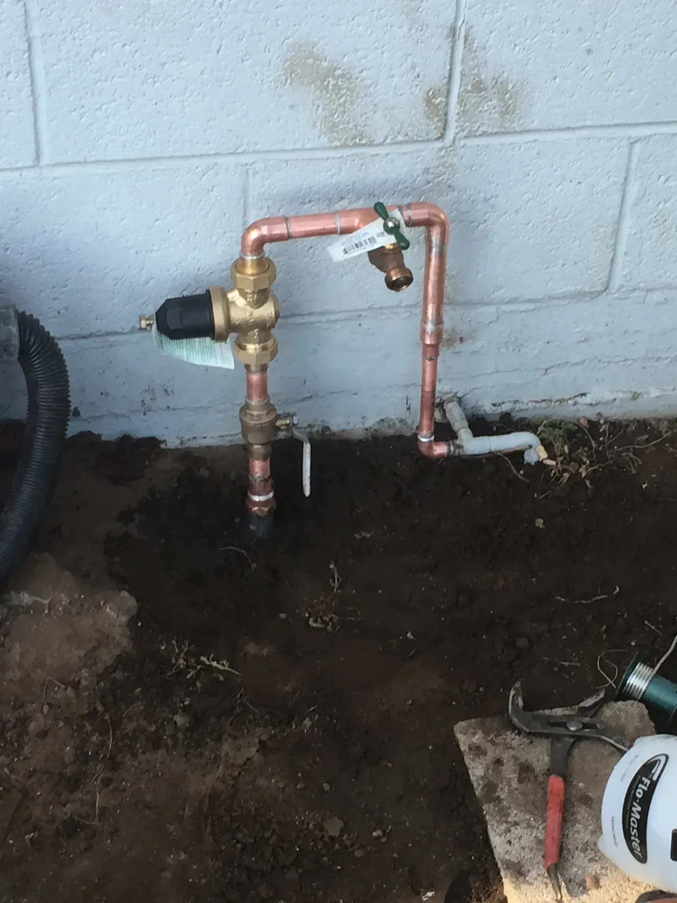A copper pipe with a valve attached to it