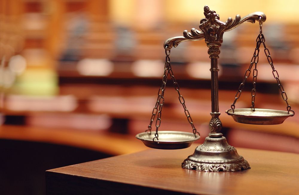 Scales of Justice on a Wooden Table, Courtroom Background — Trapski Family Law in Geelong, VIC
