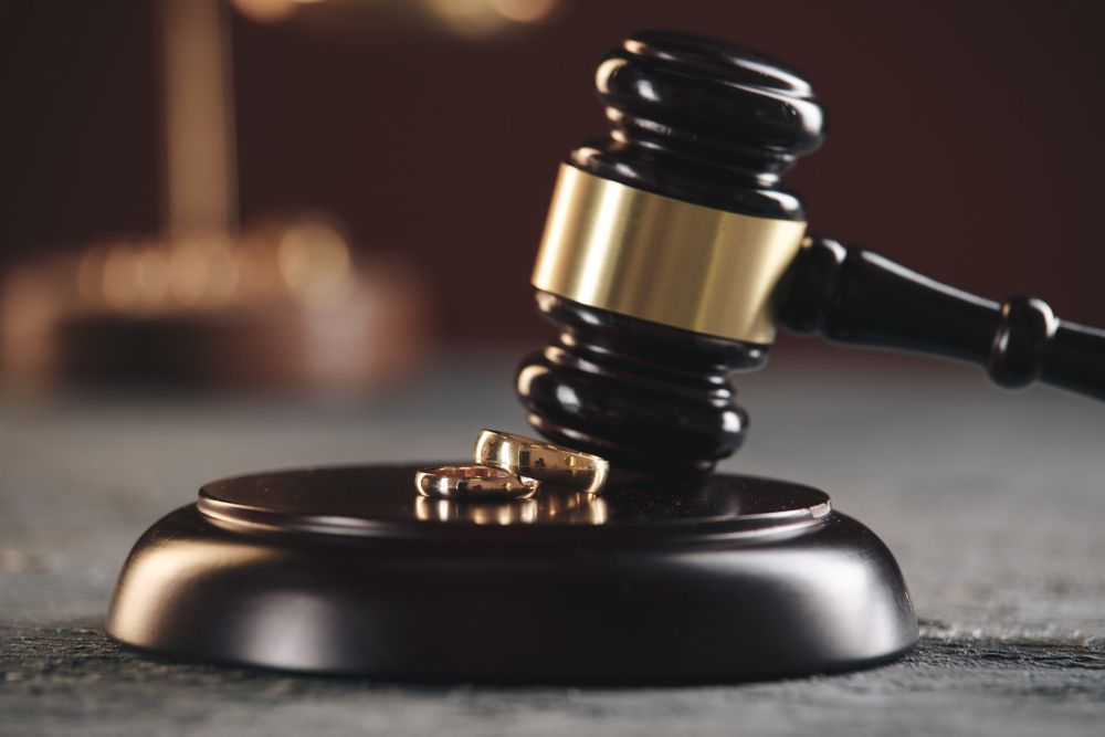 A Gavel With Two Wedding Rings, Symbolizing Divorce — Trapski Family Law in Williams Landing, VIC