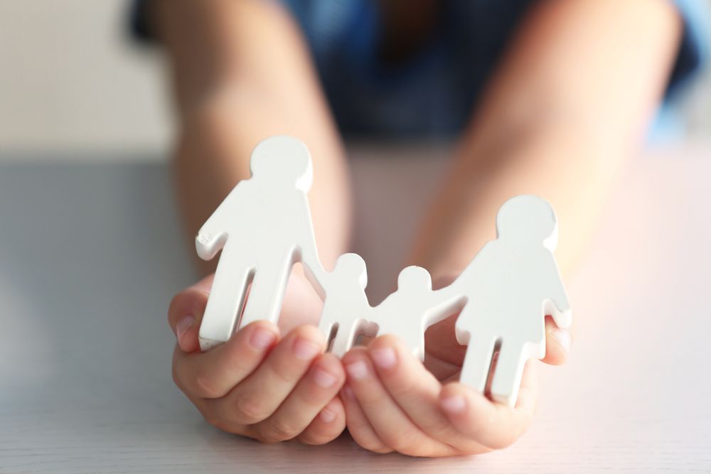 Child Holding Wooden Family Figures in Cupped Hands — Trapski Family Law in Geelong, VIC