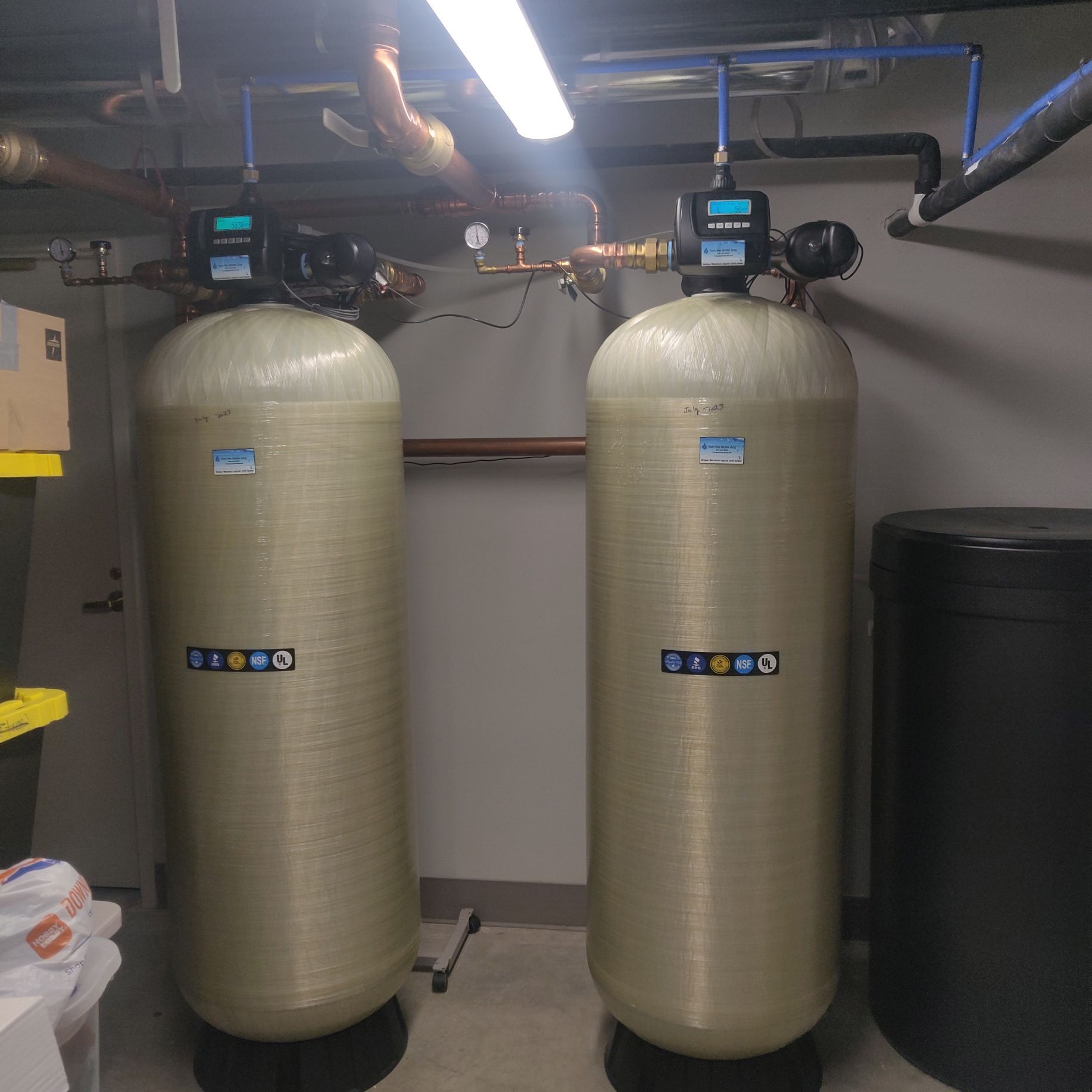 Two large tanks in a room with the letters bb on them