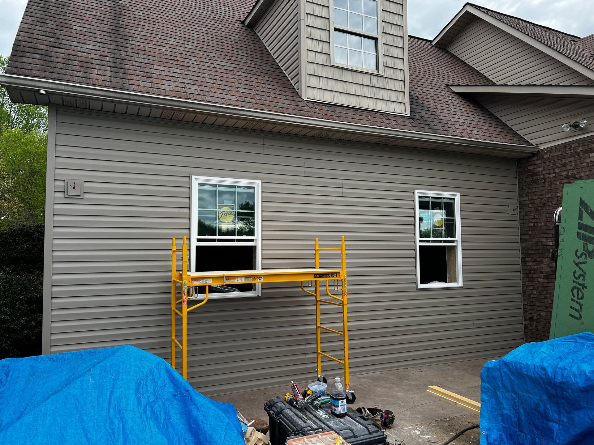 A house with a scaffolding on the side of it.