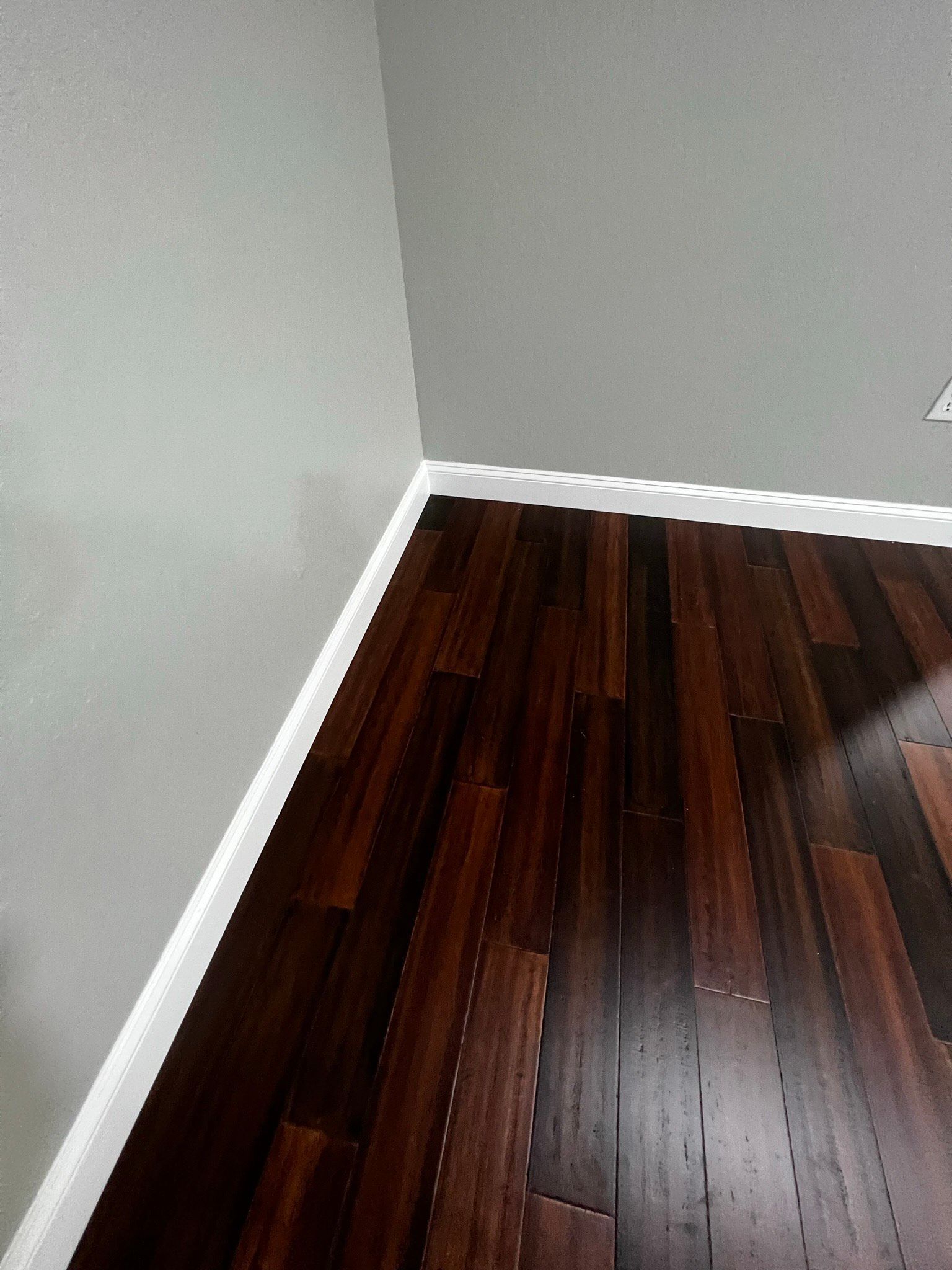 A room with a wooden floor and white trim.