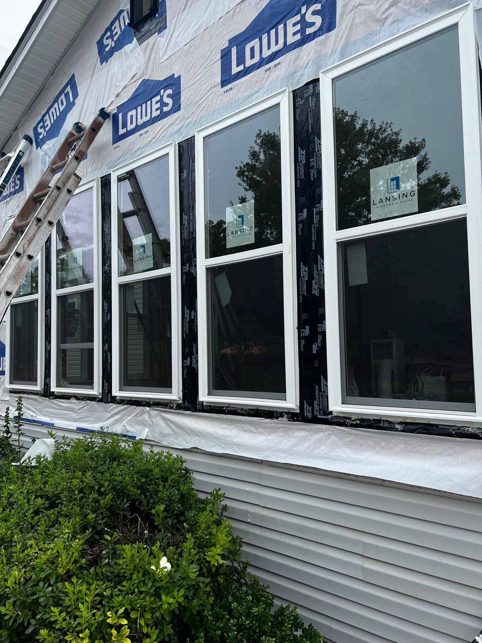 A house with a lot of windows is being remodeled.