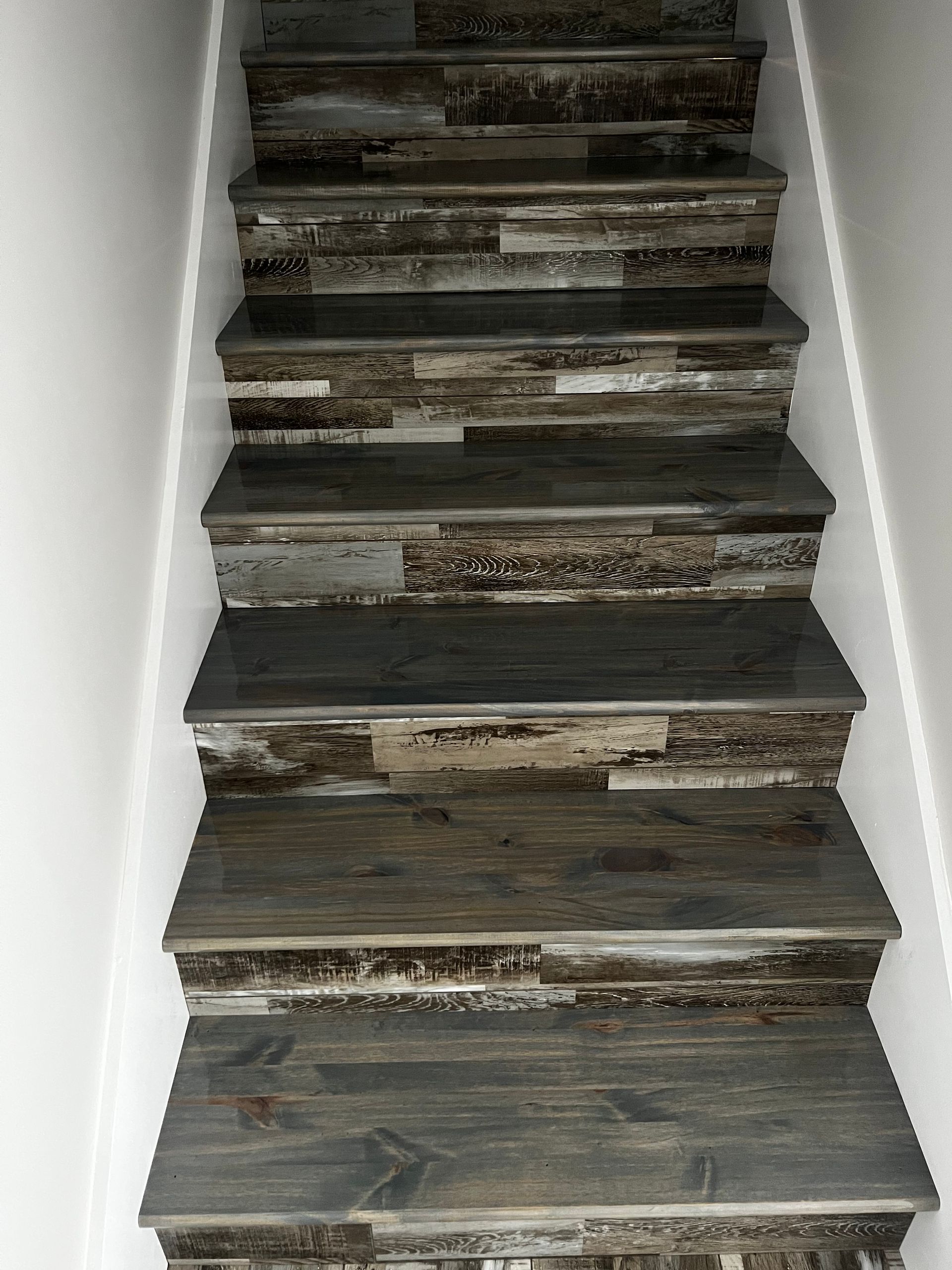 A set of stairs made of wood and tile.