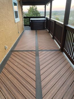 A wooden deck with a hot tub on it.