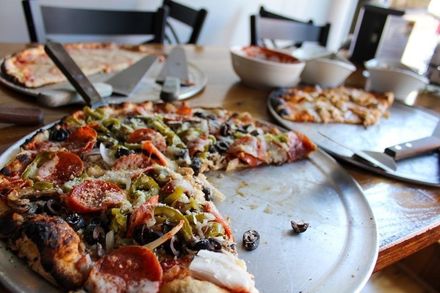 Various pizzas on trays