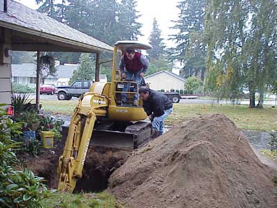 Excavator making a hole - Storage tank services in Seattle WA