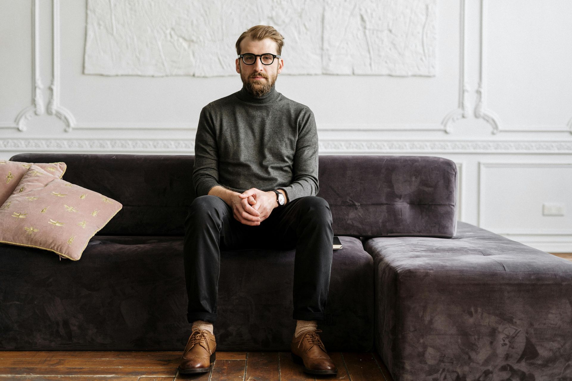 A man sitting silently on sofa