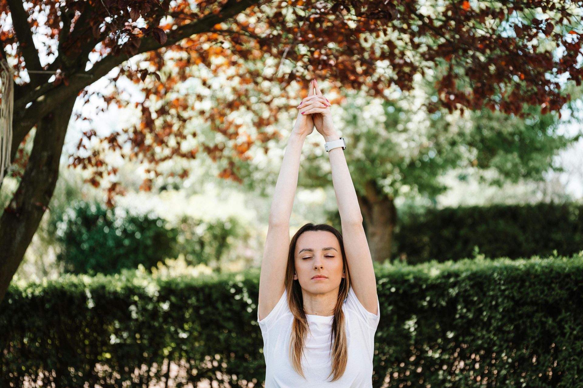 A lady exercising in a park to help improve her mental health