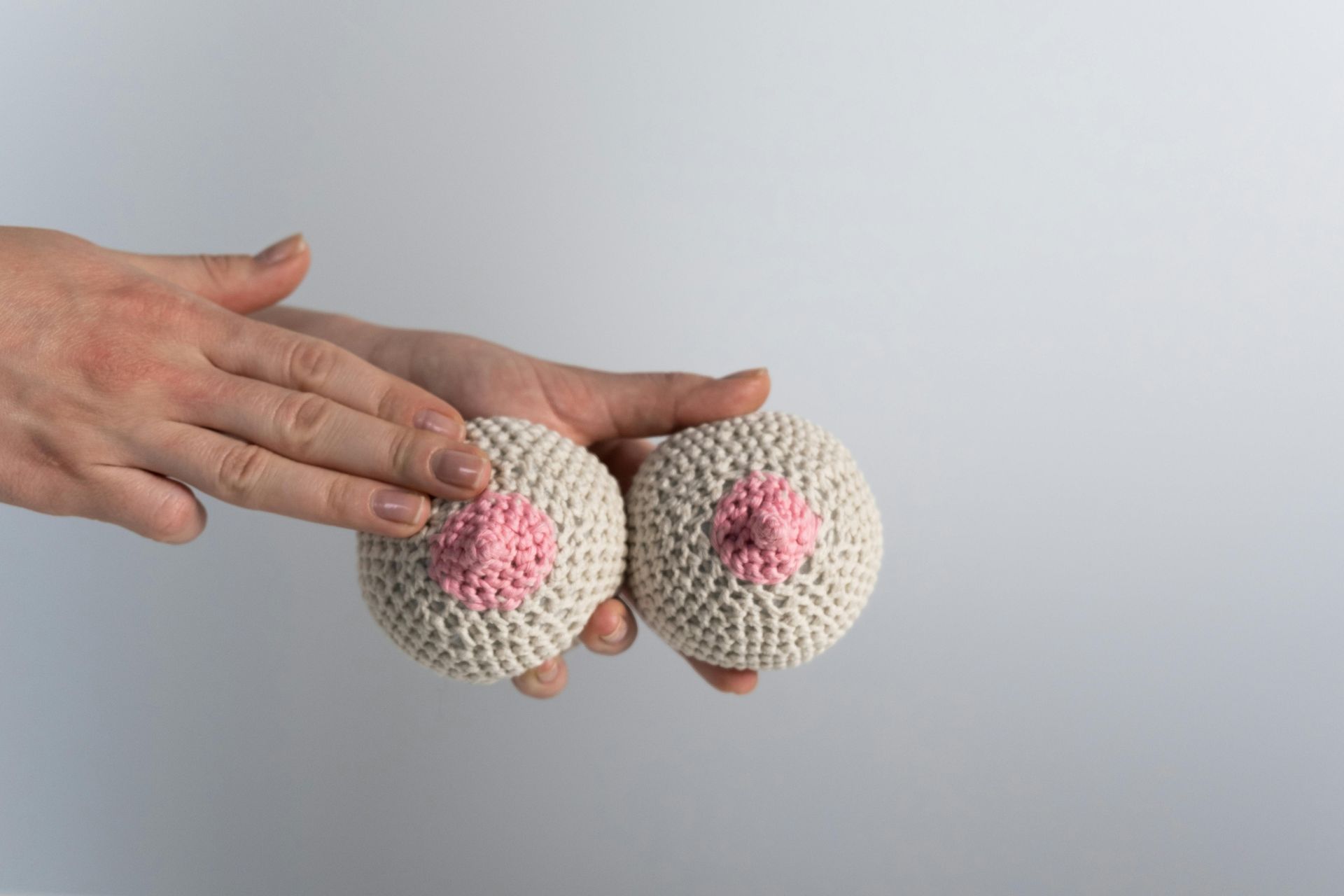 A hand holding 2 balls