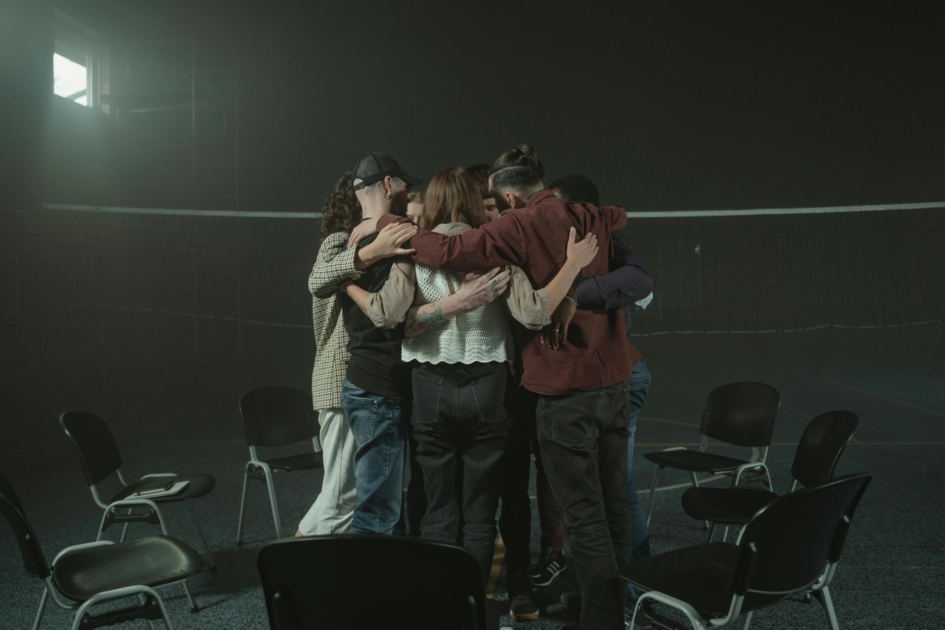 A group of people in a hug to symbolize connection