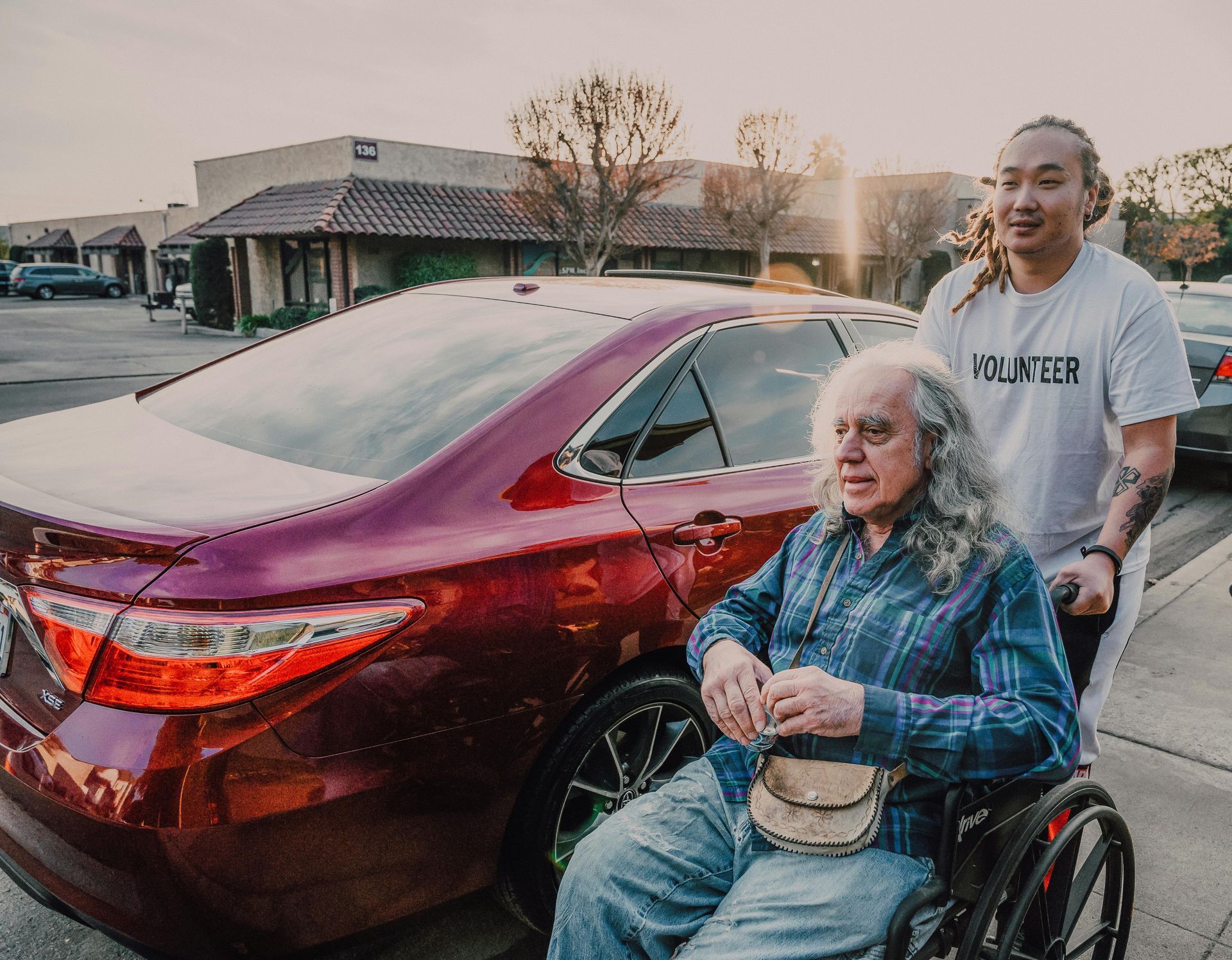 A carer pushing a disabled adult in a wheelchair