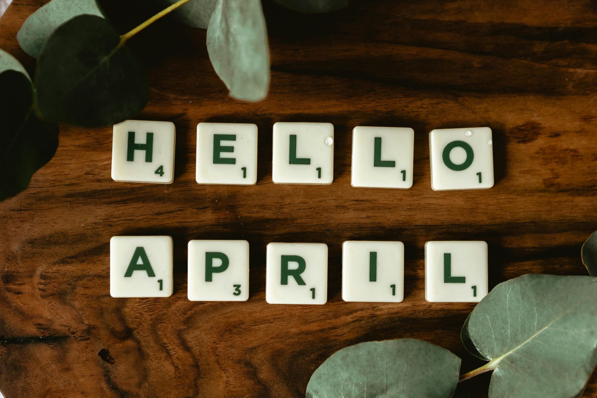 An image with scrabbles arranged to read HELLO APRIL
