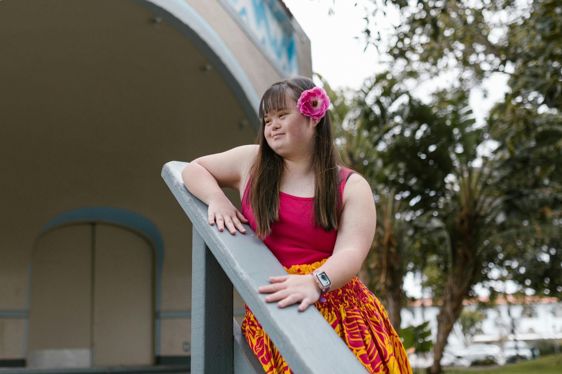 A developmentally disabled lady with flower in hair, feeling loved