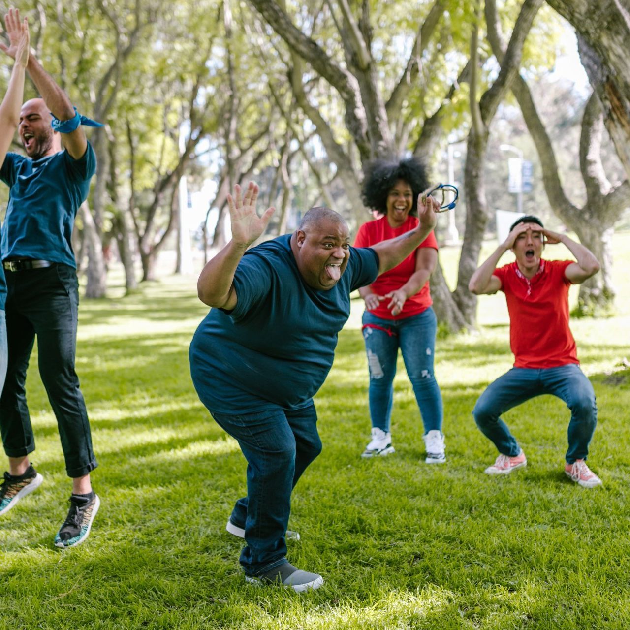 Developmentally disabled individual joyfully playing in a group with support from Direct Support Professionals (DSP)