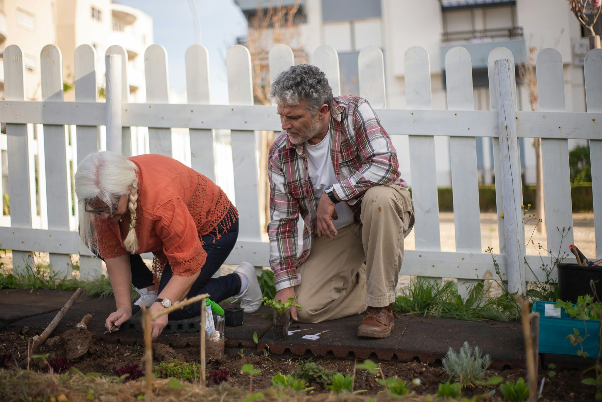 Elderly man and woman gardening