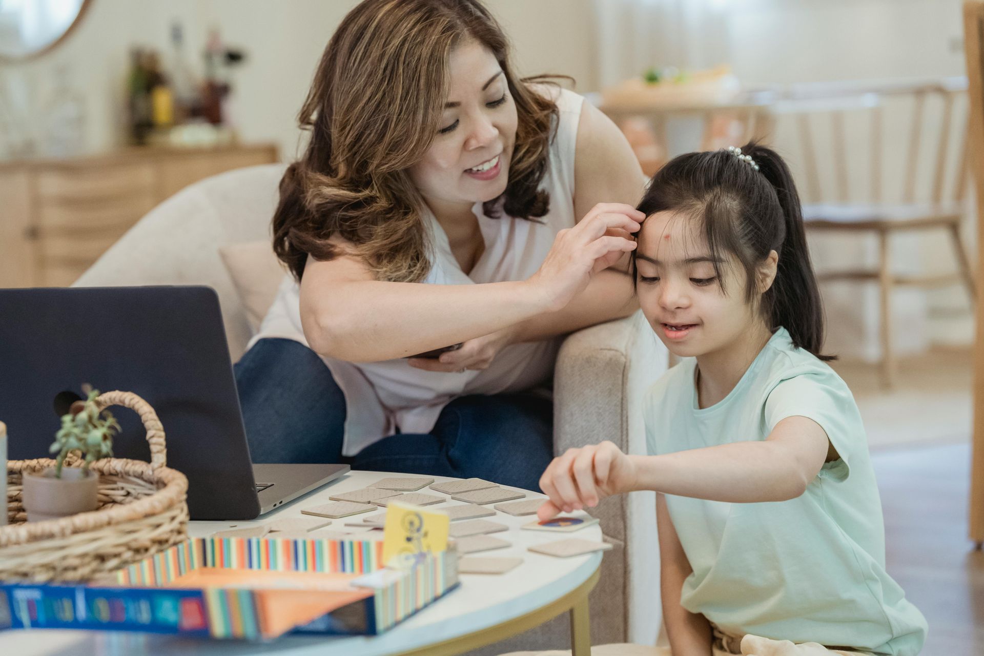 A happy parent supporting her disabled child through playing and learning