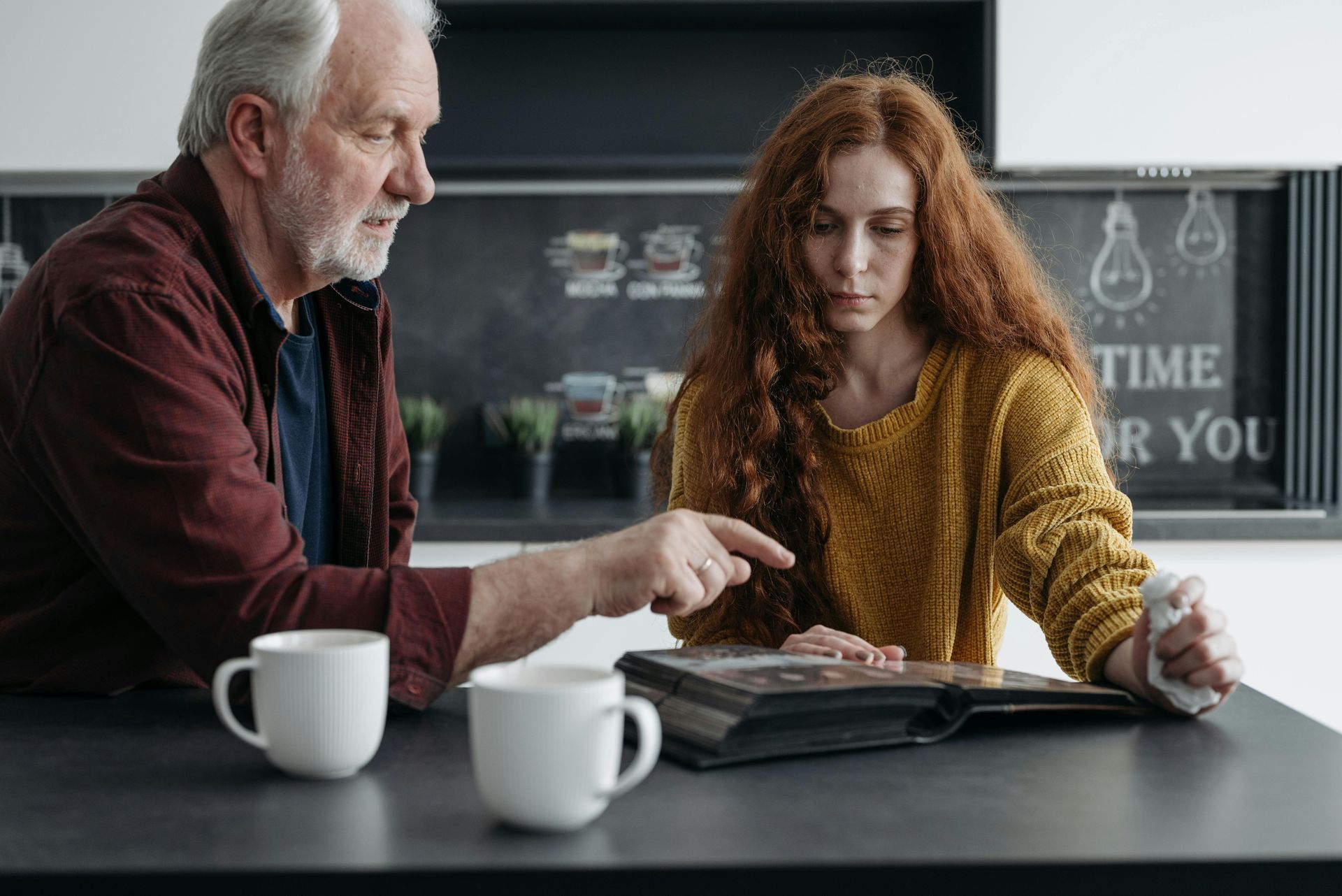 Elderly man engaging in an activity with a young lady for memory care