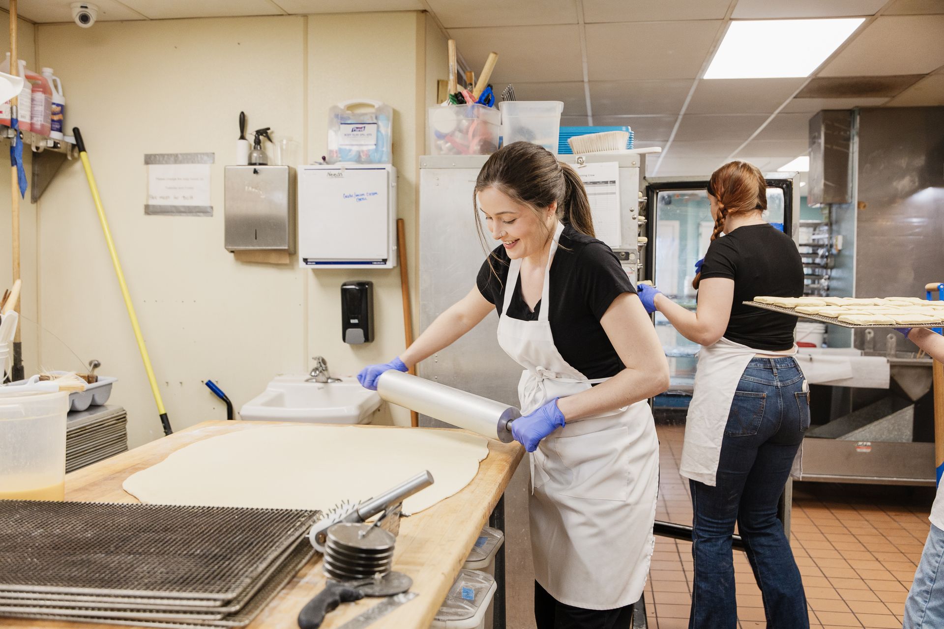 a girl holding a cookies in grove street bakery