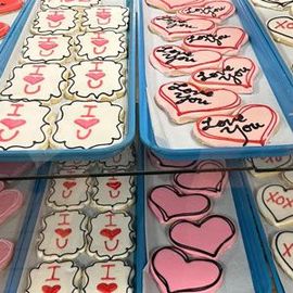 Trays of Valentine's Day cookies decorated with 